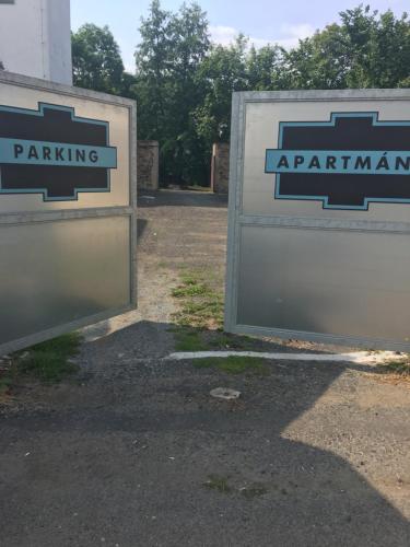 two signs that say parking and a parking apparatus at Vysocina Design Apartments in Hlinsko