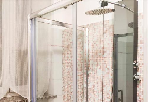 a shower with a glass door in a bathroom at B&B Ariosto 26 in Rho