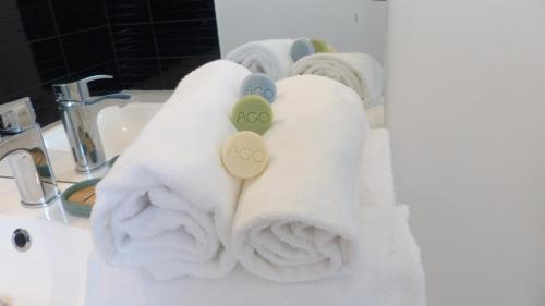 a pile of towels sitting on a bathroom sink at Ravissante maison de pêcheur Quiberon/Saint Julien in Quiberon