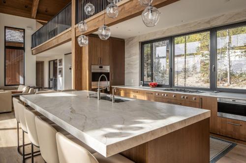 a large kitchen with a large marble counter top at Skylark Chalet in Big Sky