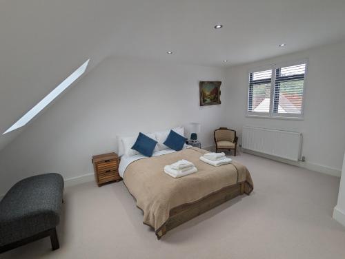 a bedroom with a bed and a chair and a window at House in Barnes in London