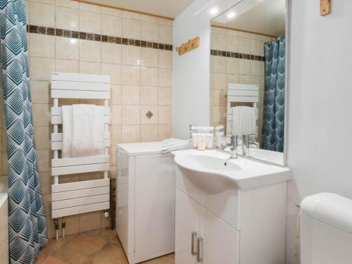 a white bathroom with a sink and a mirror at Studio Courchevel 1650, 1 pièce, 5 personnes - FR-1-563-31 in Courchevel