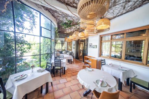 a restaurant with tables and chairs and large windows at Dar Tanja Boutique Hotel in Tangier