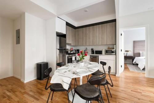 a kitchen and dining room with a table and chairs at Luxury 3BR Duplex w Private Patio in Upper East in New York
