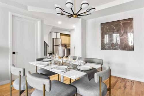 a dining room with a white table and chairs at 3BR Penthouse with Massive Private Rooftop in New York