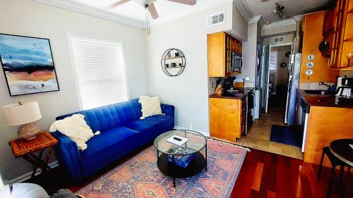 a living room with a blue couch and a table at The Hipster Studio in DTSP in St Petersburg