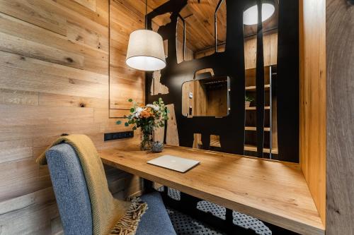 a room with a desk with a laptop on it at Rezidence Alpina in Špindlerův Mlýn