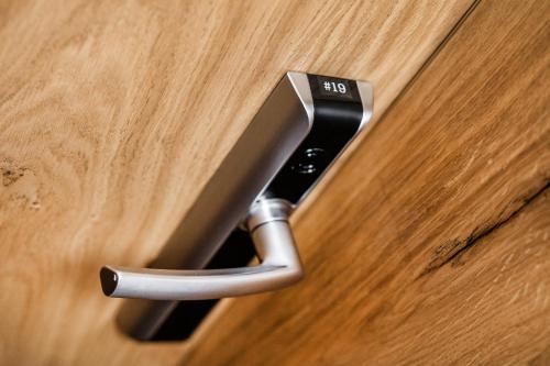 a close up of a door handle on a wooden door at Rezidence Alpina in Špindlerův Mlýn