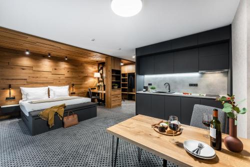 a hotel room with a bed and a kitchen at Rezidence Alpina in Špindlerův Mlýn