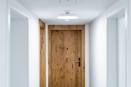 a wooden door in a room with white walls at Rezidence Alpina in Špindlerův Mlýn