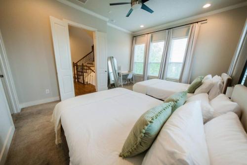 a bedroom with two beds with pillows on them at Downtown Escape - Backyard, Game room and Free Parking in Houston