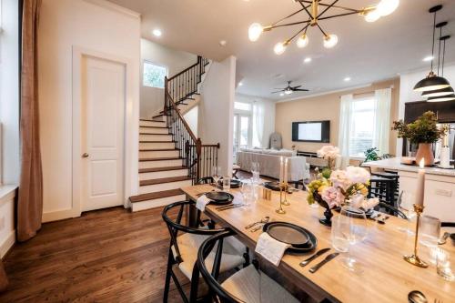 a dining room with a table and a staircase at Downtown Escape - Backyard, Game room and Free Parking in Houston