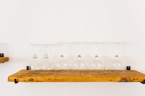 a group of glass bottles on a wooden shelf at Studio Apartment Volterra Curacao in Willemstad