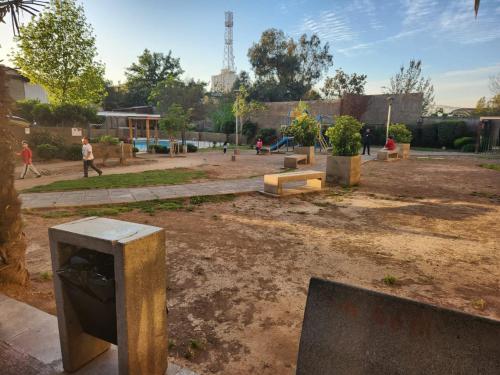 a park with a bunch of benches in the dirt at Gamero a Pasos de Metro Hospitales in Santiago