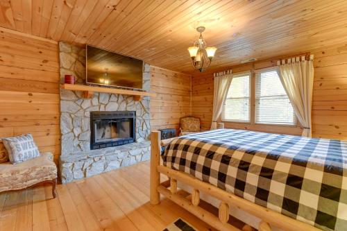 a bedroom with a bed and a fireplace at Home with Indoor Spa 8 Mi to Smoky Mtn Natl Park! in Waynesville