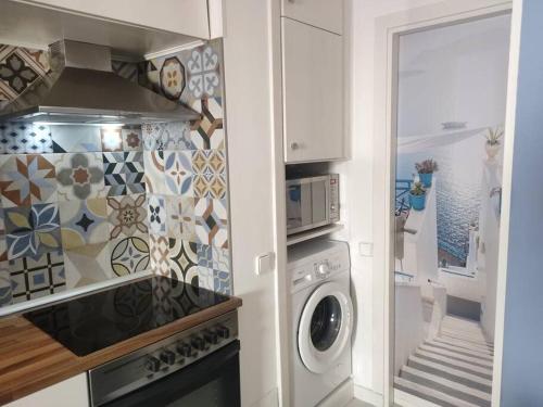 a kitchen with a washer and dryer in a kitchen at Team019 Sitges Richard España in Sant Pere de Ribes