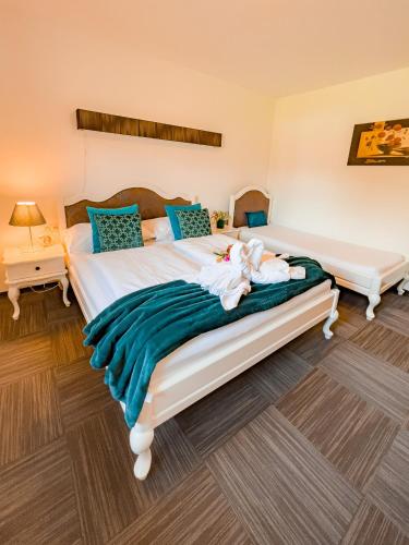 a bedroom with a large bed with blue pillows at Appartements-Dalila in Sankt Michael im Lungau