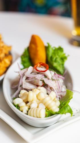 a white bowl of food on a white plate at LP Los Portales Hotel Piura in Piura