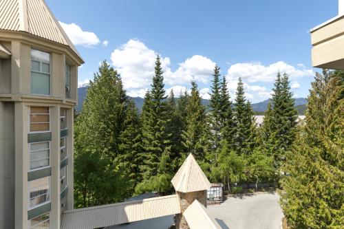 a view from the balcony of a building with trees at The Woodrun Lodge by Whiski Jack in Whistler