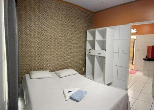 a bedroom with a bed with a laptop on it at Hotel Sorriso in Belém
