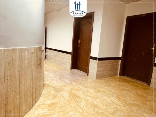 an empty hallway with flooded floors and doors at Gulf Tower in Karbalāʼ