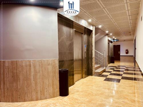 a hallway in a office building with a lobby with stairs at Gulf Tower in Karbalāʼ