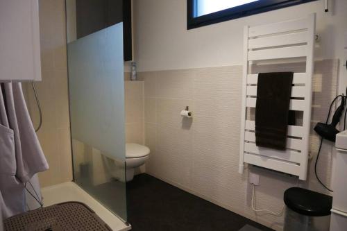 a bathroom with a toilet and a towel rack at Maison moderne proche de Paris in Montigny-lès-Cormeilles