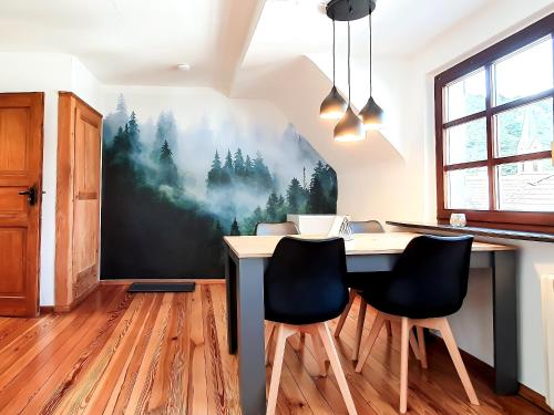 a dining room with a table and two chairs at ROMANTIC-Apartment - Altbauflair mit Dachterrasse & Waldblick, Maisonette, 80m2 in Annweiler am Trifels
