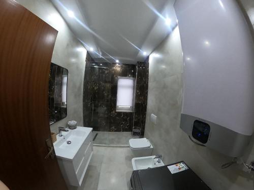 a small bathroom with a sink and a toilet at F C Tiranë in Tirana