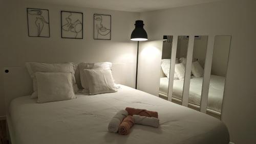 a bedroom with a large white bed with two mirrors at *J'y suis j'y reste* - proche de Paris in Villejuif