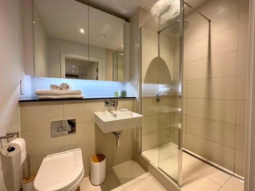 a bathroom with a toilet and a sink and a shower at Luxury 2 Bed 2 Bath Central Manchester in Manchester