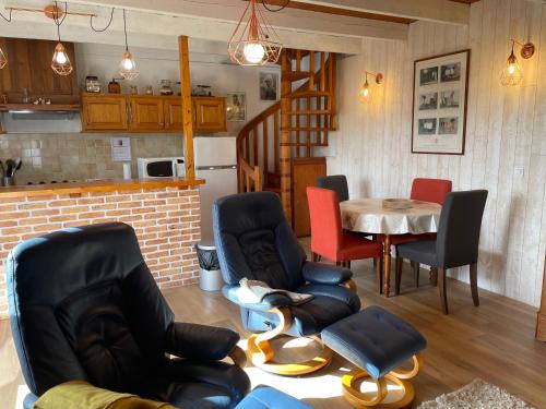 un salon avec des chaises et une table et une cuisine dans l'établissement Avel Nedeleg, à Coatreven