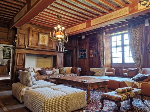 un salon avec mobilier et lustre dans l'établissement Château le But et sa Guest House proche de Périgueux en Dordogne, à Léguillac-de-Lauche