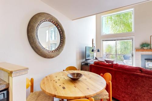 a living room with a wooden table and a mirror at Western Dreams in Sun Valley