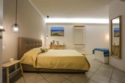 a bedroom with a large bed and a mirror at Domus Zapata in Naples