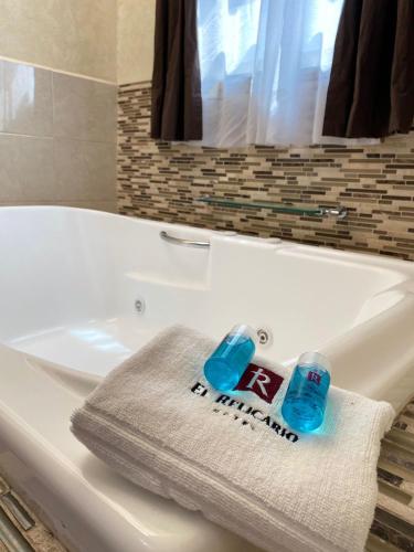 a white bath tub with a towel sitting on it at Hotel El Relicario in Dolores Hidalgo