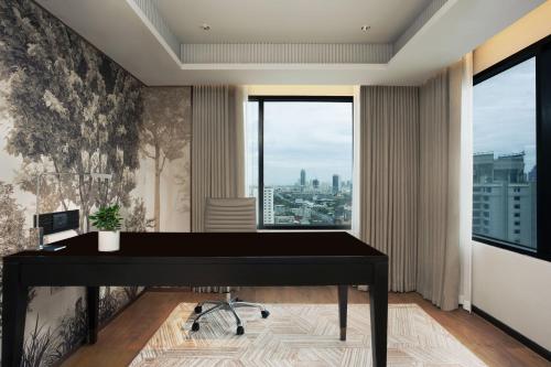 a black piano in a room with a window at JW Marriott Hotel Bangkok in Bangkok