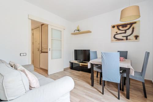 a living room with a white couch and a table at Sagrada Familia Avenida Gaudi Views&cozy Lounge in Barcelona