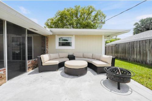 a patio with a couch and a table at Paradise Found Luxurious Retreat with Heated Pool in Rockledge