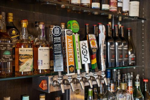 a bar with a bunch of bottles of alcohol at Executive Inn & Suites Oakland in Oakland