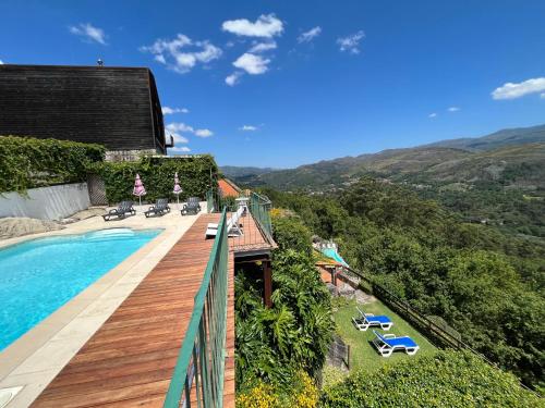 a balcony with a swimming pool and a resort at Casas das Olas in Arcos de Valdevez