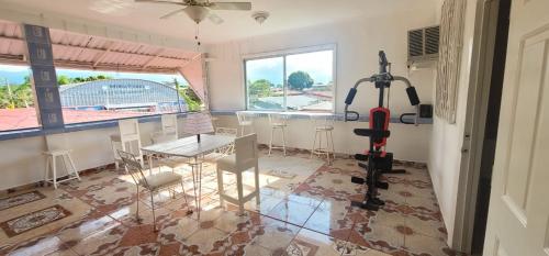 拉塞瓦的住宿－hotel trinidad，配有桌椅和跑步机的客房