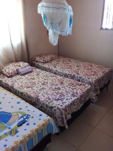 2 camas individuales en una habitación con sábanas en Casa pé na areia ao lado de Mangue Seco, en Jandaíra