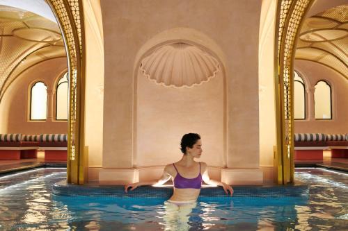 a woman in a swimming pool at a hotel at W Budapest in Budapest