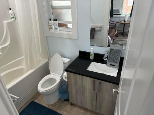 a small bathroom with a toilet and a sink at Guest Suite Private Retreat- Honeymoon Suite- J-1 in Abbotsford
