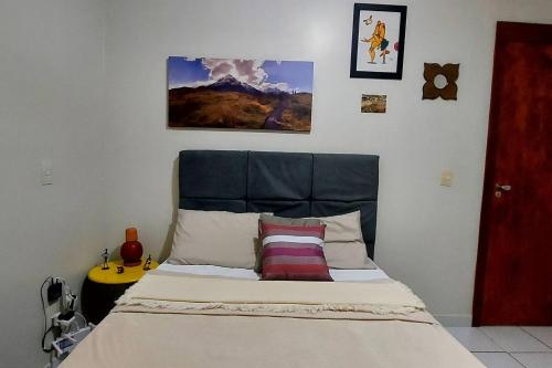 a bedroom with a bed with two pillows on it at Confortável apt em Parauapebas in Parauapebas