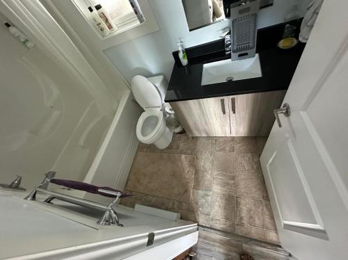 a small bathroom with a sink and a chair at Guest Suite - Private Retreat - J-1 in Abbotsford