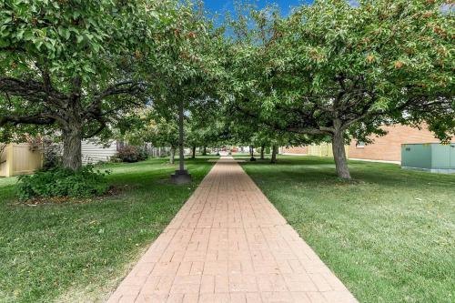 a brick path in a park with trees at Downtown & Upscale in Buffalo