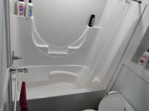 a white bathroom with a tub and a toilet at Guest Suite - Private Retreat - J-1 in Abbotsford