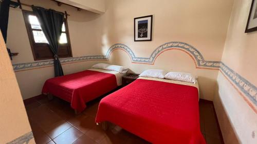 A bed or beds in a room at Posada Los Naranjos